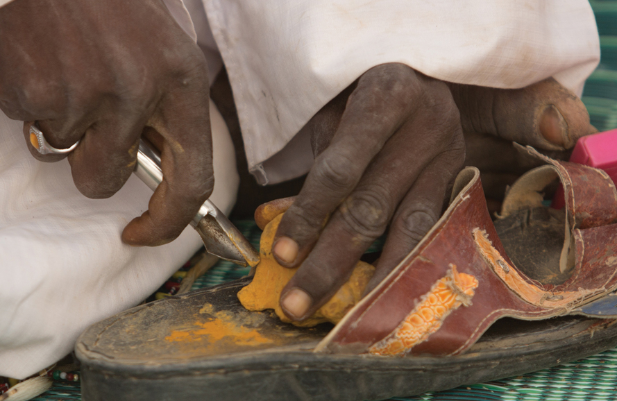 The yellow makeup being scraped from a stone found in the desert.