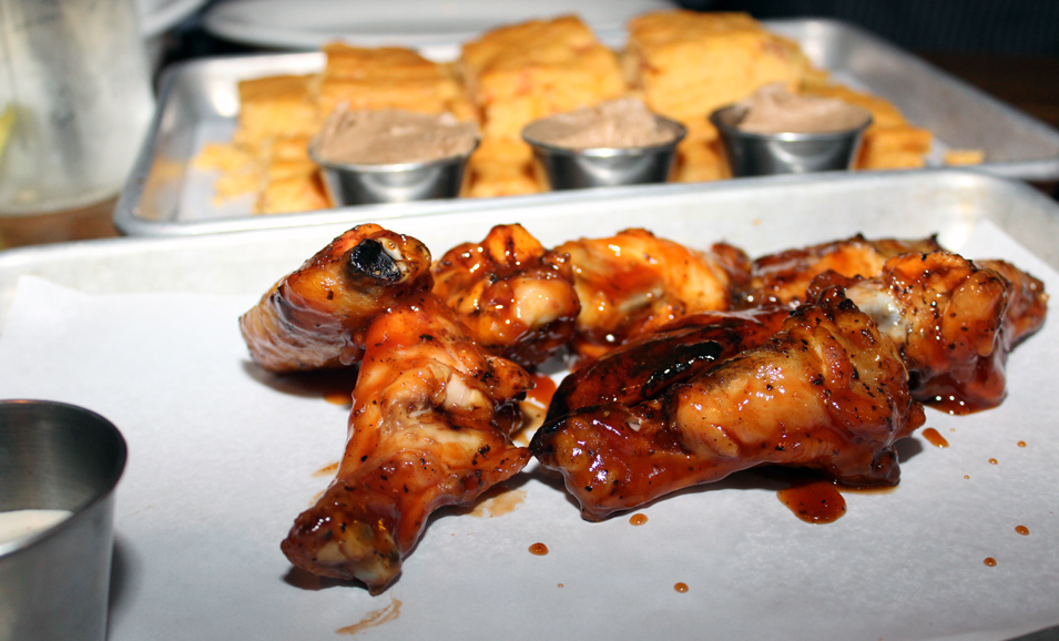 House-smoked chicken wings slathered with sweet house-made Bar BQ sauce. Photograph by Aleesia Forni.