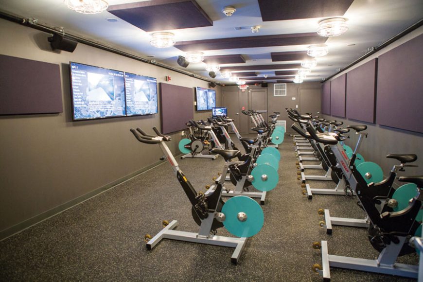 The cycling studio, where cyclers can watch their performance via a personal avatar on the studio’s television screen. Photograph by Starlight Studioz.