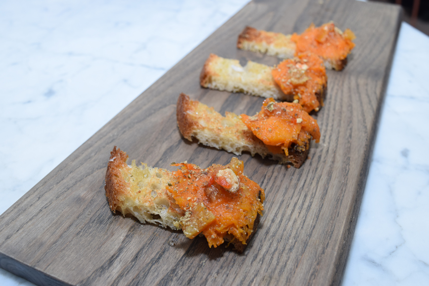 Roasted pumpkin "toast" with pepitas seeds and chilies. Photograph by Aleesia Forni.