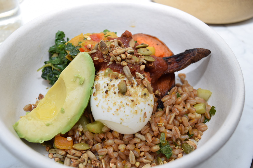 A market bowl with brown rice, avocado, kale, a hard-boiled egg and roasted carrots with kale and pumpkin seed pesto. Photograph by Aleesia Forni.
