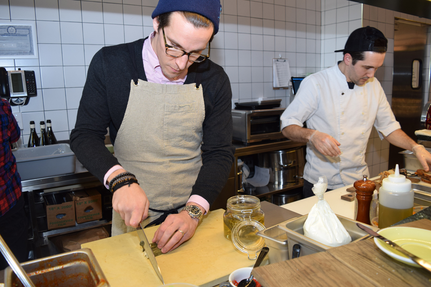 CEO Adam Eskin helps create some of the scratch cooked dishes in the open kitchen area. Photograph by Aleesia Forni. 