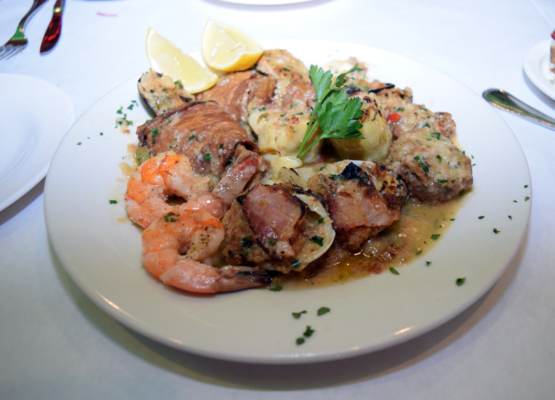 A plate of antipasto features shrimp, clams, stuffed mushrooms, eggplant and artichoke. Photograph by Aleesia Forni.