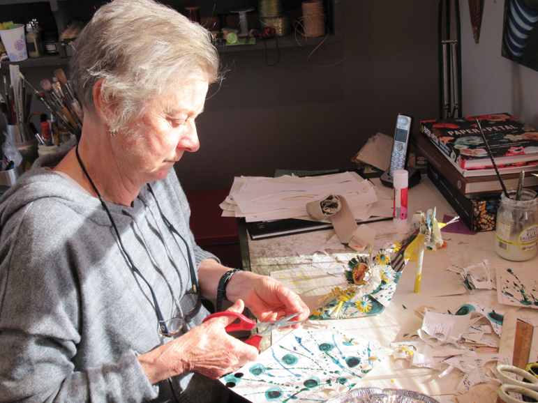 Paper artist Linda Filley at work in her Millbrook studio. Photograph by Mary Shustack.