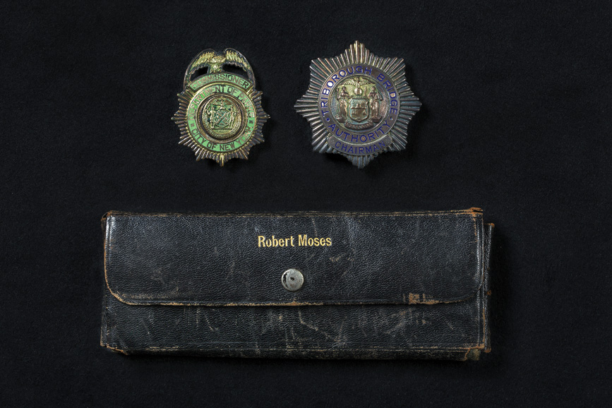 Badges owned by Robert Moses, with case: “Commissioner, Department of Parks, City of New York” (left) and “Chairman, Triborough Bridge Authority,” 1924-1960. Museum of the City of New York, gift of Mary and Helen O’Sullivan, 94.64.7. Courtesy Museum of the City of New York.