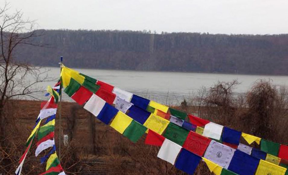 Buddhist flags outside Square Peg Gallery in Hastings-on-Hudson, which opens its latest exhibition, “Pilgrimage,” Jan. 6. Courtesy Square Peg Gallery.