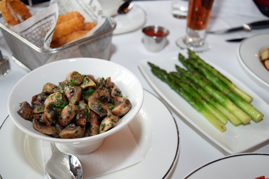 Crisp asparagus and seasoned mushrooms serve as excellent accompaniments to the eatery’s main dishes. Photograph by Aleesia Forni.