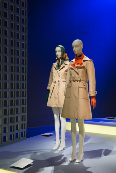 Main gallery of “Paris Refashioned, 1957-1968.” Trench coats by Yves Saint Laurent Rive Gauche (left) and Couture Future by André Courrèges (right). Photograph courtesy The Museum at FIT.