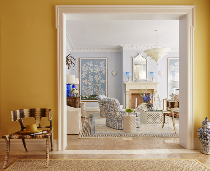 The broad portal connecting the foyer and living room of a Palm Beach home frames designer Marshall Watson’s signature blue and yellow palette, reminiscent of Vincent van Gogh. Photograph by Max Kim-Bee.