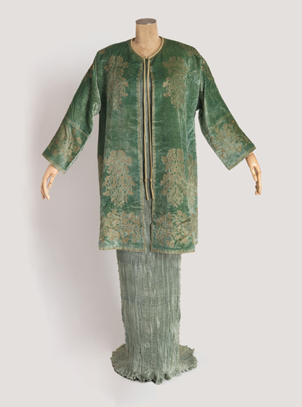 Delphos dress and jacket with box, 1939; Designed by Mariano Fortuny (Spanish, active Italy 1871–1949); Manufactured by Societa Anonima Fortuny (Venice, Italy); Dress: pleated silk; Jacket: stencil-printed silk velvet; Dress: 162.6 × 35.6 cm (5 ft. 4 in. × 14 in.); Jacket: 91.4 × 86.4 cm (36 × 34 in.) Cooper Hewitt, Smithsonian Design Museum, Museum purchase from the Members’ Acquisitions Fund of Cooper-Hewitt, National Design Museum, 2016-28-1-a,b; Photograph by Matt Flynn. © Smithsonian Institution.