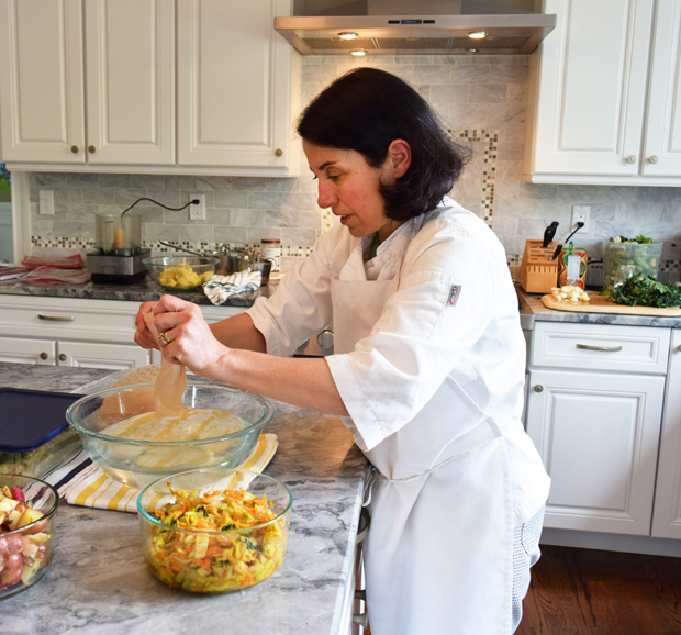 Laurie Gershgorn prepares a meal in a client’s home in Tarrytown. Photograph by Aleesia Forni.