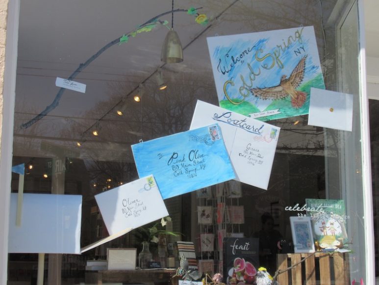 The window of Pink Olive in Cold Spring celebrates its opening in the Hudson Valley. Photograph by Mary Shustack.
