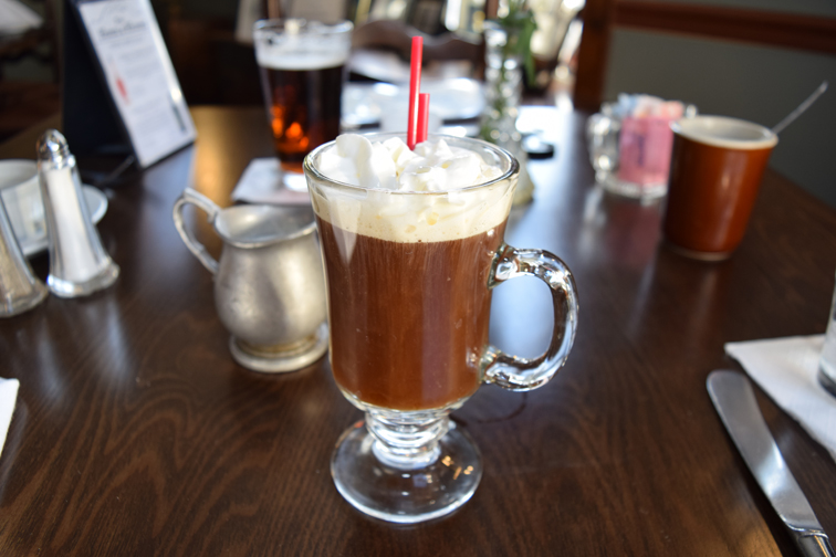 Warm Irish coffee is topped with whipped cream. Photograph by Aleesia Forni.