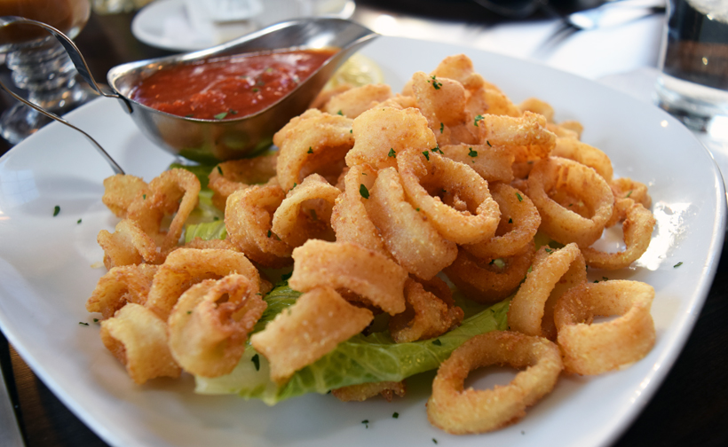 Crispy calamari is served with a cup of sweet marinara sauce. Photograph by Aleesia Forni.