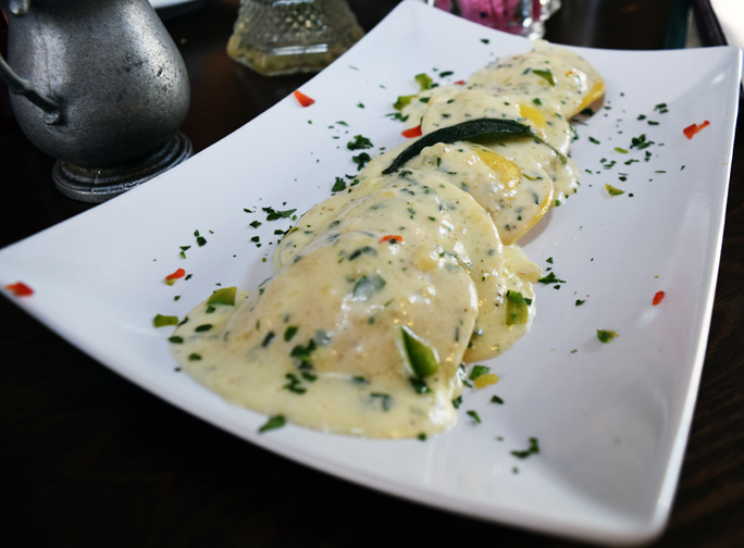 Butternut squash ravioli is drizzled in a sage sauce. Photograph by Aleesia Forni.