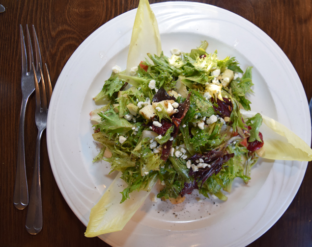 Endive salad is garnished with apples, cranberries, blue cheese and walnuts. Photograph by Aleesia Forni.