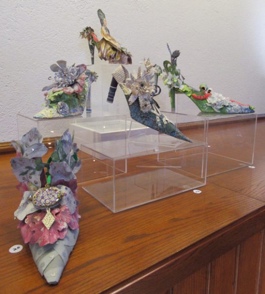 A collection of 30 paper shoes created by artist Linda Filley are artfully displayed throughout The Norfolk Library in Litchfield County, Connecticut, this month. Photograph by Mary Shustack.