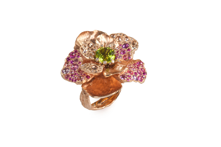 An 18-karat, rose-gold ring adorned with sapphires in shades of yellow, deep pink and blue, brown diamonds and white diamonds accenting the pistils, $12,000. Photograph courtesy Vendorafa.
