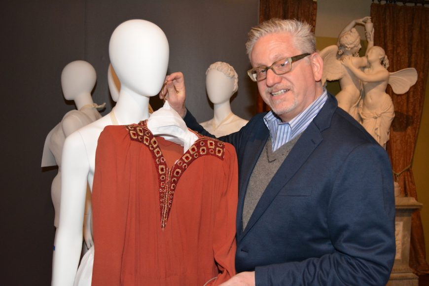 Howard Zar, executive director of Lyndhurst, with an Anna Gould dress featured in “Defying Labels: New Roles, New Clothes.” The beaded red day dress, circa 1940, is by Maison Burano of Fifth Avenue. Photograph courtesy Lyndhurst.