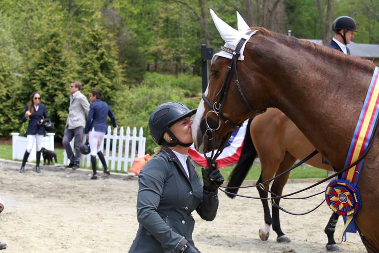 Penny Brennan congratulates Sun Tzu with a kiss after they won the $15,000 Speed Derby at the Old Salem Farm Spring Horse Shows. Photograph by Lindsay Brock for Jump Media.