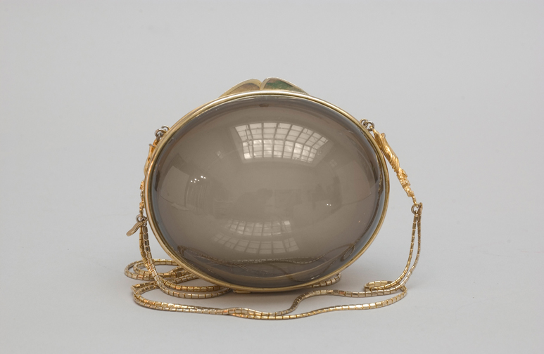Smoked Lucite egg with gold frame and chain, 1968. Photograph by Gary Mamay. Courtesy the Leiber Collection.