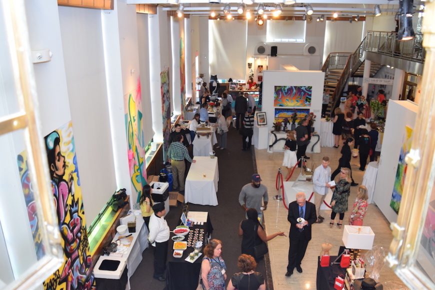 Attendees taking in the exhibits on the first-floor gallery at ArtsBash. Photograph by Aleesia Forni.