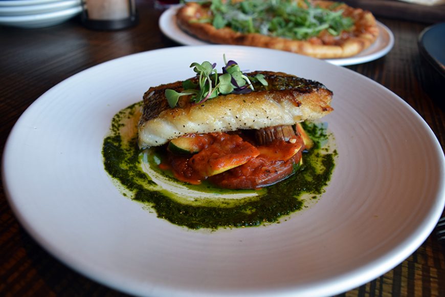 Sea bass is served over a tasty zucchini and eggplant ratatouille. Photograph by Aleesia Forni.