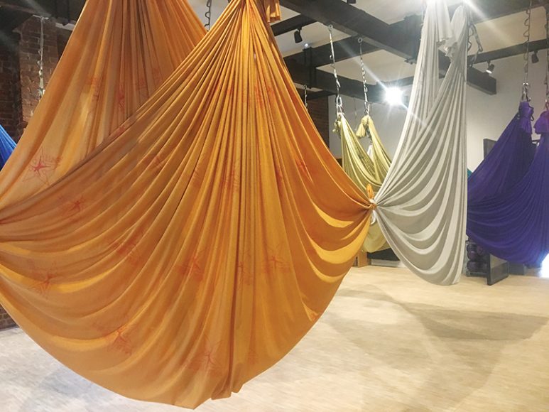In the aerial yoga class, yogis use these colorful hammocks to help with stretching, resistance and meditation. Photograph by Danielle Renda.