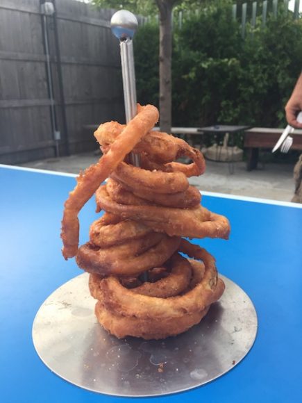 A highlight of the menu is a tower of crispy battered onion rings. 
