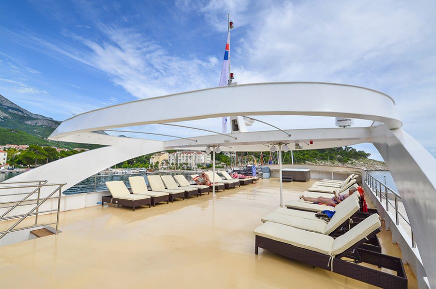 One of the many deck areas aboard Karizma, where guests can comfortably sunbathe beneath the Croatian sun.  Courtesy Sloane Travel Photography.