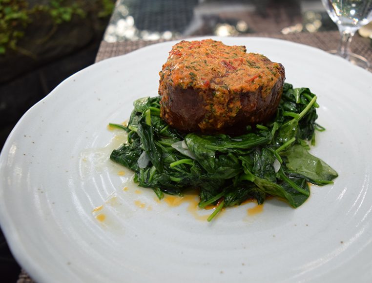Filet mignon with wilted spinach. Photograph by Aleesia Forni.