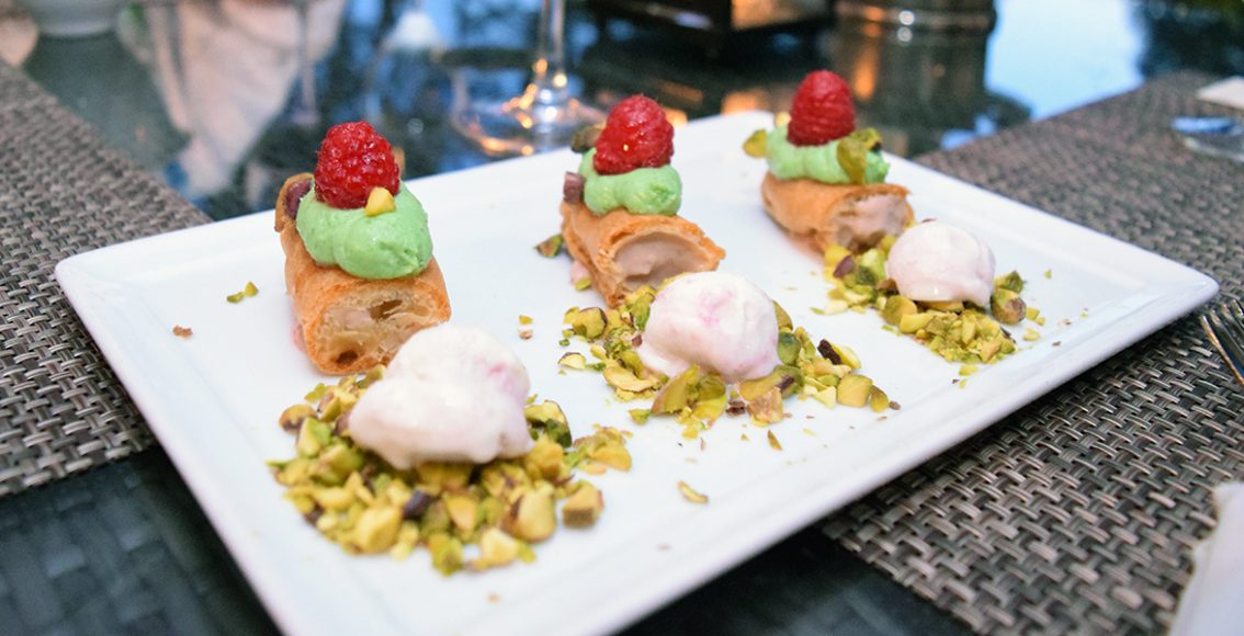 Eclairs feature raspberry pastry cream and ice cream, pistachio whipped cream and white chocolate. Photograph by Aleesia Forni.