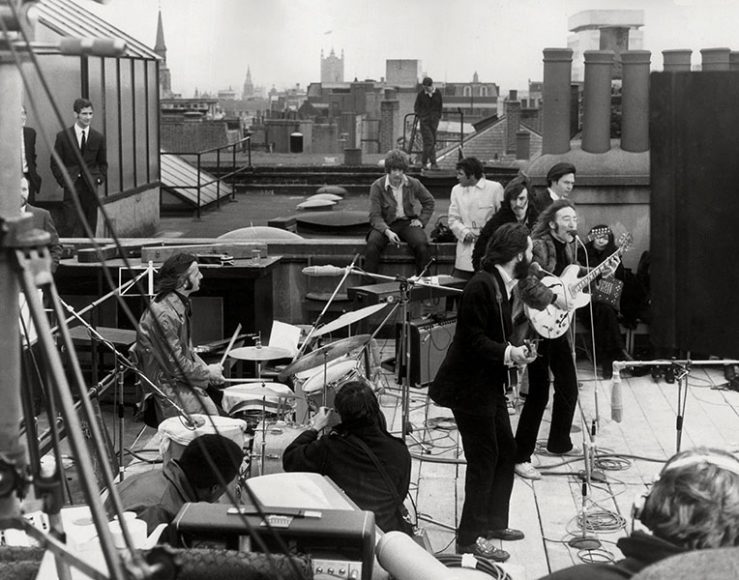 The Beatles play their last live gig on the roof of the Apple building at No. 3 Savile Row in 1969: a “happening” that many of the tailors still remember today. Both Paul McCartney and John Lennon are wearing Tommy Nutter suits. Getty Images. Image from "Bespoke: The Masters Tailors of Savile Row" (Thames & Hudson.)