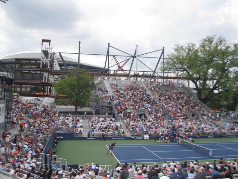Andrey Rublev on his way to upsetting world No. 7 Grigor Dimitrov at the temporary Louis Armstrong Stadium. Construction for the new one looms in the background.