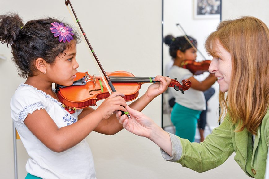 A young violinist at Hoff-Barthelson Music School. Photograph by Steven Schnur.