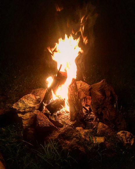 Sitting around a fire underneath the night sky in Asheville. Photograph by Danielle Renda. 