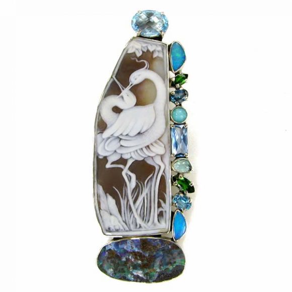 This pin/pendant features a crane design masterfully carved in Italy with accent stones of blue topaz, opal, tourmaline and amazonite. Courtesy Amy Kahn Russell.