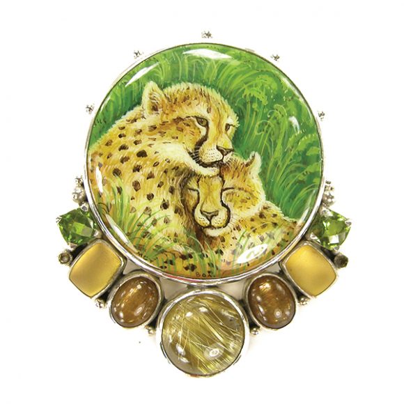 A leopard painting, a Russian miniature, on black onyx with accent stones of peridot, quartz and rhutilated quartz set in sterling silver. Image courtesy Amy Kahn Russell. 