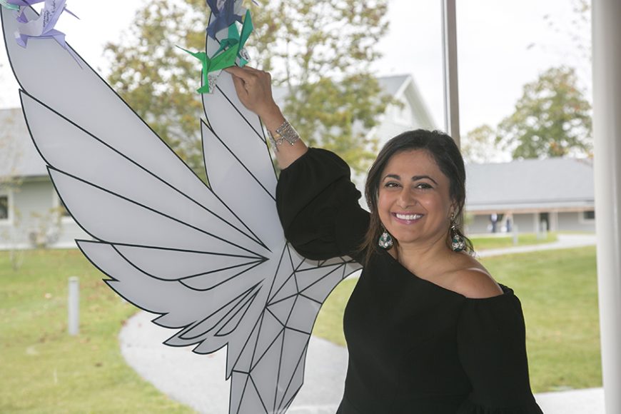 Krishna Patel adds her own message of hope to the hummingbird-shaped collage. Photograph © Hogarth Worldwide. Courtesy Grace Farms Foundation.