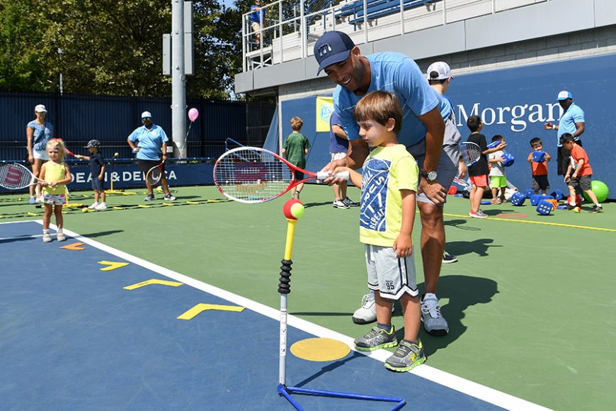 James Blake working a with youngster. Photograph courtesy USTA.