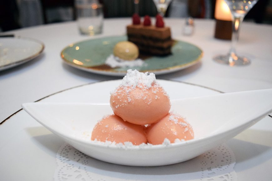 Three scoops of blood orange sorbet are topped with coconut flakes. Photograph by Aleesia Forni.