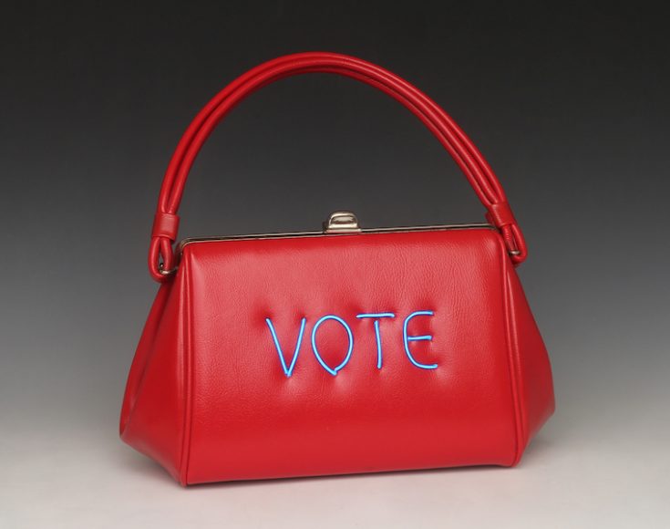 Michele Pred’s “Women’s Vote,” (2017),  electroluminescent wire on vintage handbag.