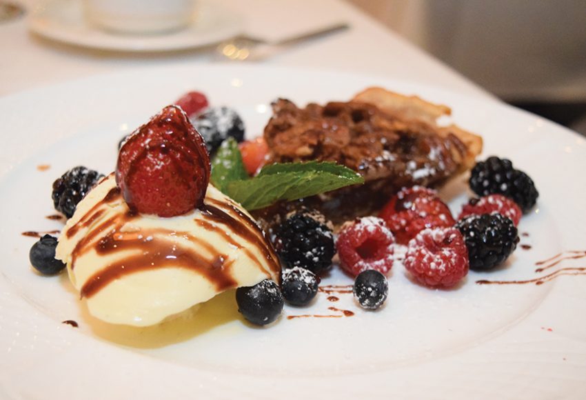 Warm walnut pecan pie served with creamy vanilla ice cream. Photograph by Aleesia Forni.