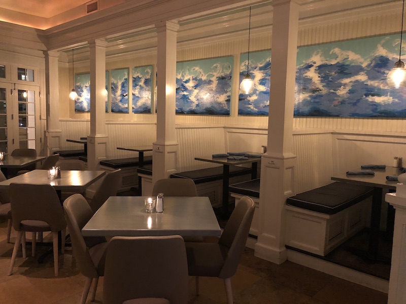 Painted shoreline scenes line the dining room’s walls.
