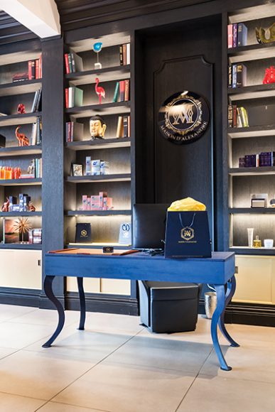 The décor of Maison D’Alexandre is that of a spa or an old-fashioned lounge. Pictured here is the front desk, with products displayed in a floor-to-ceiling bookcase. Photograph courtesy Maison D'Alexandre.