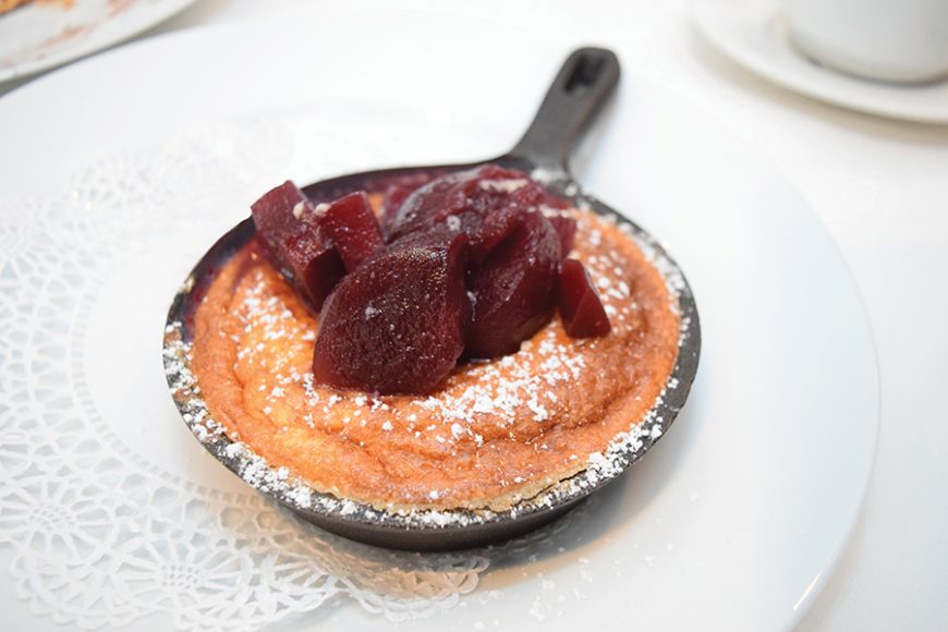A vanilla soufflé is topped with red wine-poached pears. Photograph by Aleesia Forni.