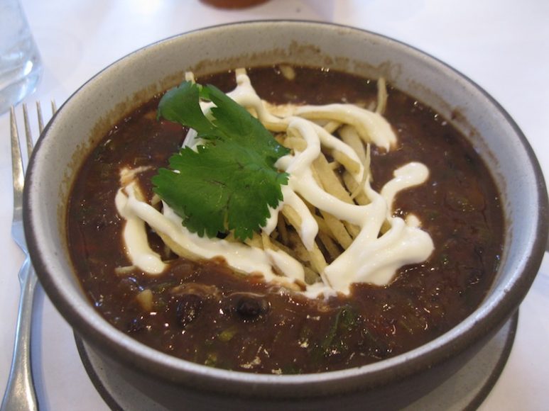 At the New York Botanical Garden’s Hudson Garden Grill, we and fellow patrons relished a Southwestern-style black bean soup; a meaty crabcake dressed in red onions and perched on a bed of avocado; creamy mango, raspberry and coconut sorbet; and a most fetching, floral chocolate cake. 