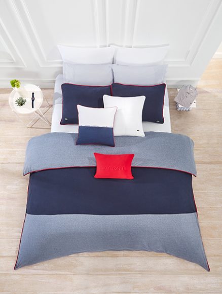 The three-piece cotton full/queen comforter set is available in chili pepper (red), gray and navy. ($315). Photograph 
courtesy Lacoste.