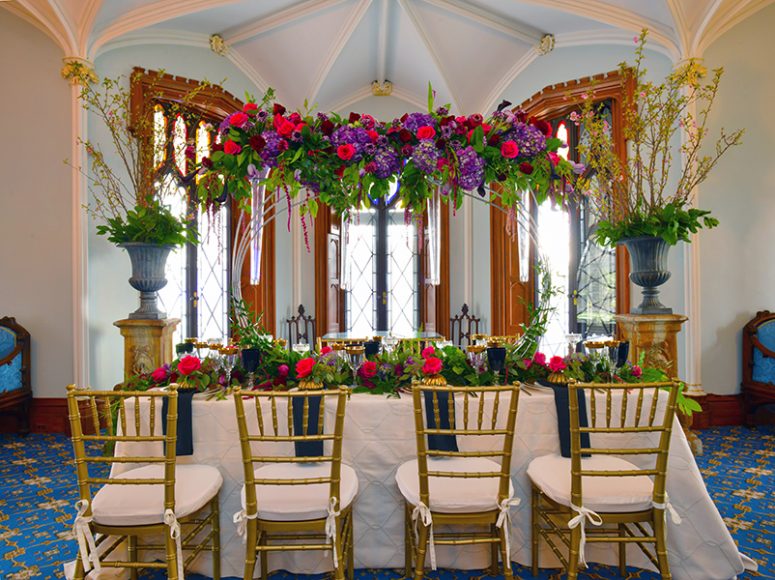 A stunning table with a floral arch created by Joseph Richard Florals of Armonk fills the parlor/drawing during the recent flower show at Lyndhurst. Photograph by Bob Rozycki.