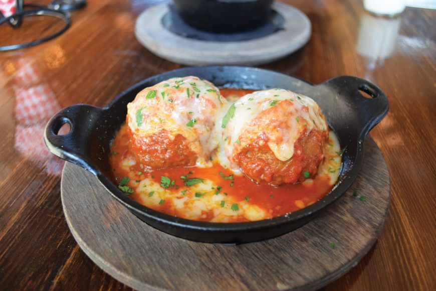 Meatballs are made with pork, veal and beef and topped with marinara, Provolone and parsley.